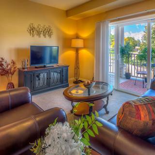 Cozy living room with modern decor and access to a balcony.