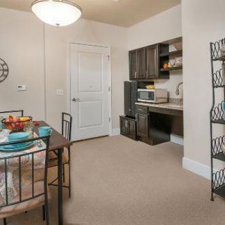 A cozy kitchenette and dining area in a small apartment.