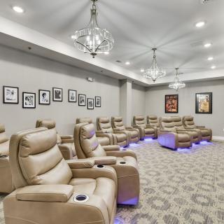 A modern home theater with comfortable recliner seating and elegant lighting.