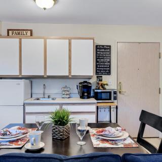 A modern kitchen with a neatly set dining table featuring contemporary appliances and dcor.