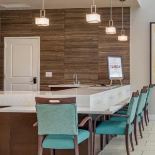 Modern kitchen with a sleek dining area and stylish pendant lighting.