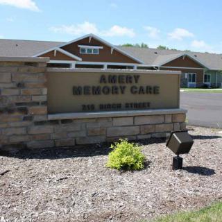 Sign for Amery Memory Care outside a building.