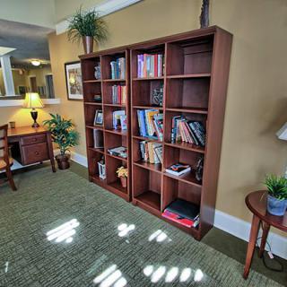Cozy library corner with bookshelves and comfortable seating.