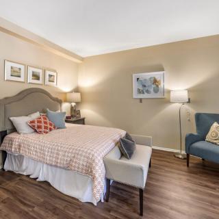 A cozy and stylish bedroom with modern decor featuring a comfortable bed, elegant furniture, and warm lighting.