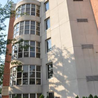 A multi-story building with large, curved windows on its facade.