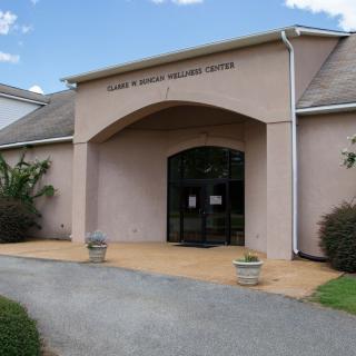The entrance of a library building with a pathway leading to the doors.