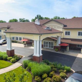 Aerial view of a residential building with landscaped gardens and a welcoming entrance.