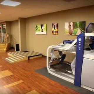 A modern gym interior with exercise equipment and a treadmill.