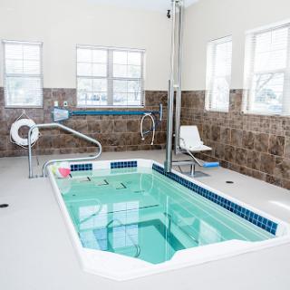 A serene indoor therapy pool designed for relaxation and accessibility.