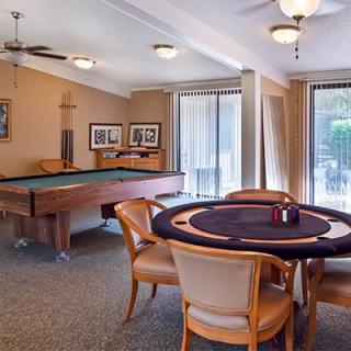 A cozy game room featuring a billiards table and a poker table, perfect for leisure and entertainment.