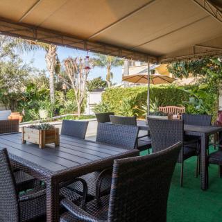 Outdoor patio seating area surrounded by lush greenery.