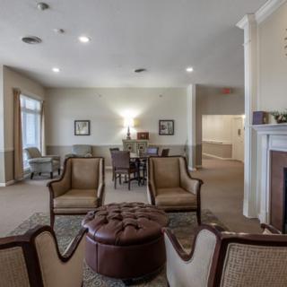 A spacious living room with elegant furniture and a cozy fireplace.
