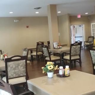 A cozy dining area featuring tables and chairs, creating a welcoming atmosphere for gatherings.