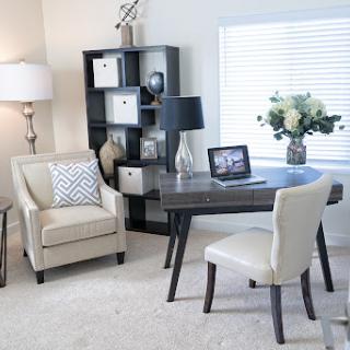 A stylish home office setup featuring modern furniture and a cozy atmosphere.