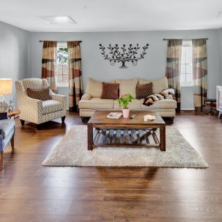 A cozy living room with a comfortable couch, armchairs, a wooden coffee table, and stylish decor.