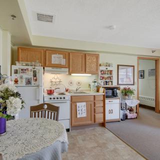 Cozy apartment kitchen with dining area.