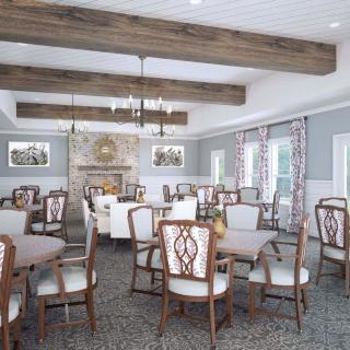 A spacious and elegantly decorated dining room with wooden beams, chandeliers, and a fireplace.