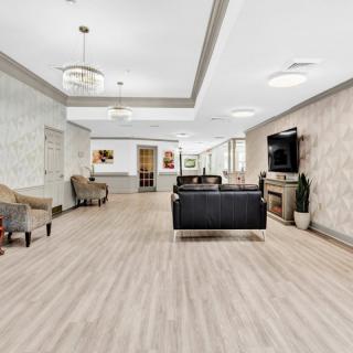 A modern lobby with seating area and television.