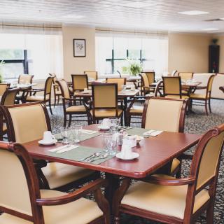 An elegant dining room with neatly arranged tables and chairs.