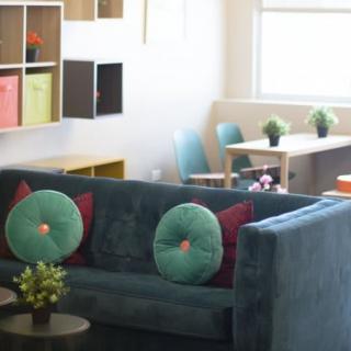 A modern living room with a comfortable sofa, colorful pillows, and stylish decor.