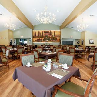 Elegant restaurant dining area with neatly arranged tables and chandeliers.