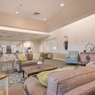 A spacious and modern living room with comfortable seating and stylish decor.