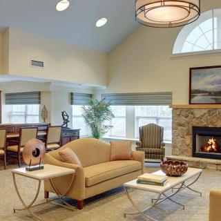 A cozy living room with a fireplace, elegant furniture, and modern lighting.