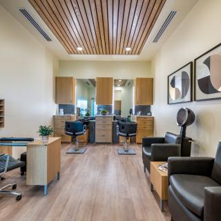 Modern hair salon interior with stylish furniture and artwork.
