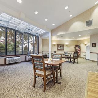 A bright and spacious dining area with large windows allowing natural light to fill the room.