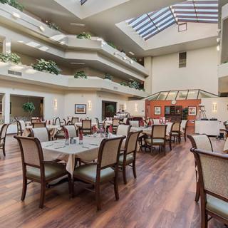 Spacious dining area with elegant furnishings and natural lighting.