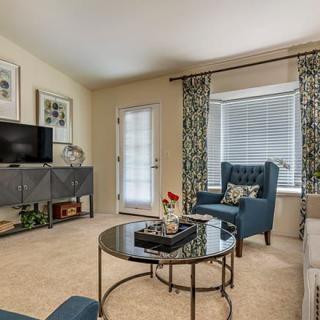 A modern living room featuring stylish furniture and decor with a comfortable seating area.