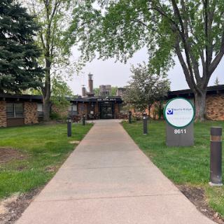 A welcoming entrance path leading to a building surrounded by greenery.