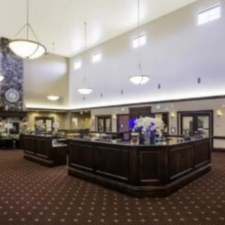 Interior view of a bank with teller stations and elegant lighting.