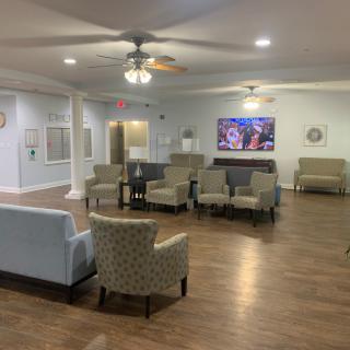 A spacious living room with comfortable seating and a large television.