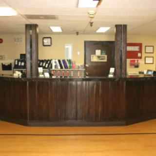 A wooden reception desk in an office setting.