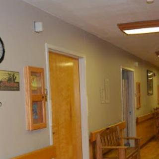 A serene hallway featuring wooden benches and decorative elements.