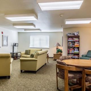 Comfortable lounge area with seating and bookshelves.