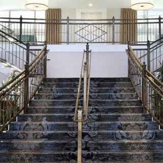A modern staircase with decorative railings and symmetrical design.