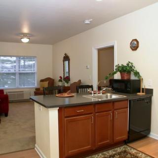 Open layout kitchen and living room with modern furnishings.