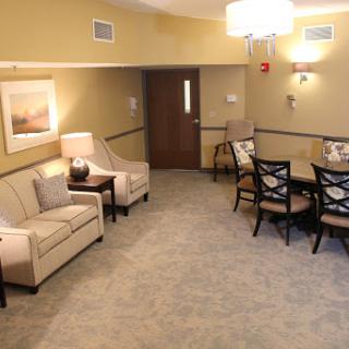 A cozy living and dining space featuring comfortable furniture and warm lighting.