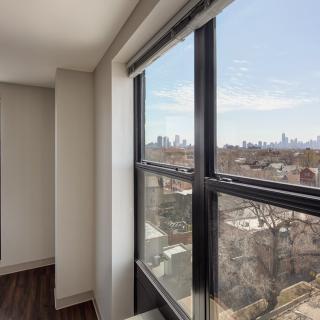 A high-rise apartment with a clear view of the city skyline.