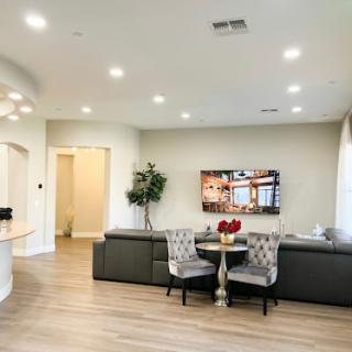 A modern living room featuring sleek furniture and a cozy dining area.