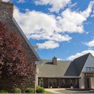 A picturesque building under a partly cloudy blue sky.