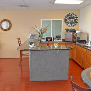 A welcoming office reception area with a counter and coffee machine.
