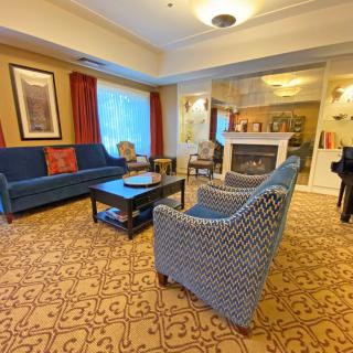A cozy living room with comfortable seating and a fireplace.