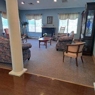 A cozy living room space featuring comfortable seating and natural light.
