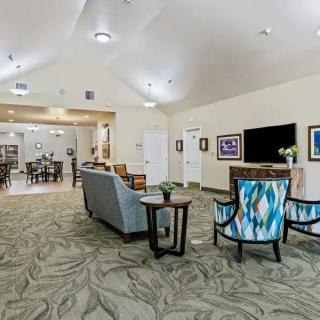 A spacious and stylish living room featuring modern furniture and decor.