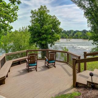 A serene deck overlooking a river, surrounded by lush greenery.