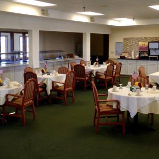 A restaurant dining room with tables set for service.