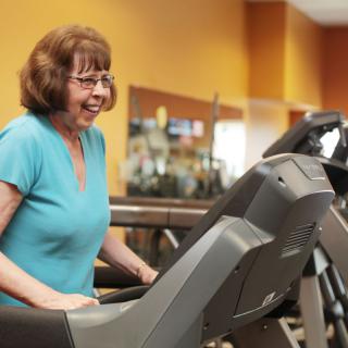 A woman exercising on a treadmill at the gym.